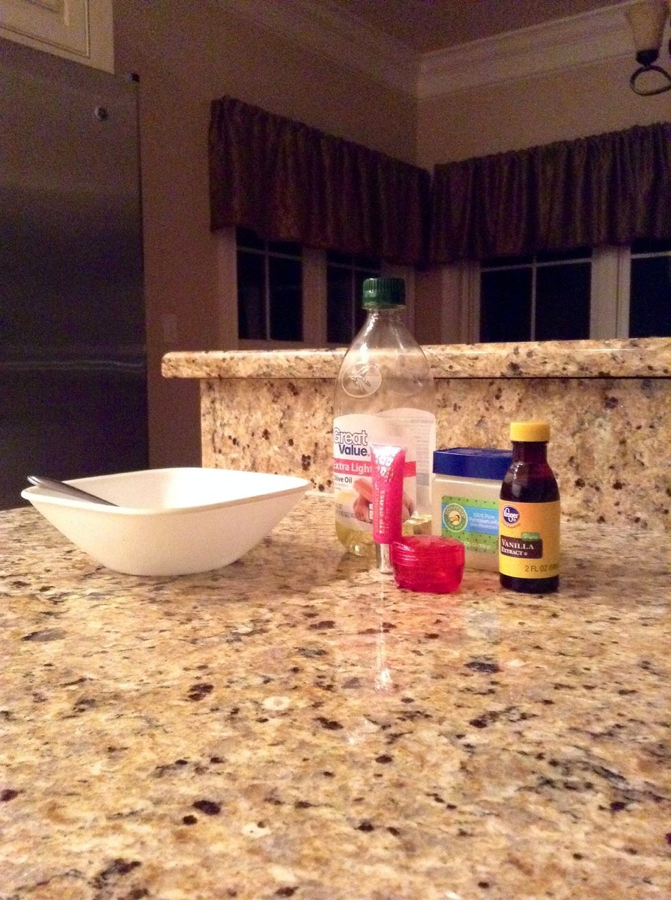 First, gather your supplies. You will need a microwave safe bowl, a spoon, olive oil, a colored lipgloss, petroleum jelly (Vaseline), a container to put your lip product in, and any flavoring.