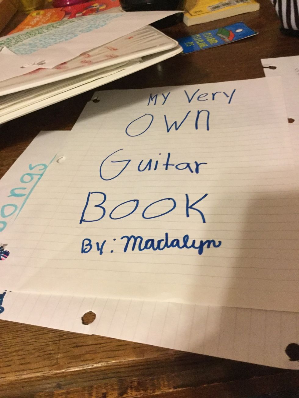 First get a piece of paper and write "My Very Own Guitar Book" By: your name