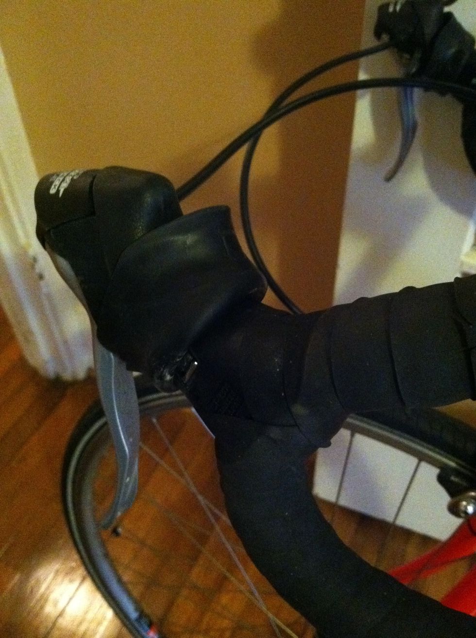 First get everything out of the way so you can remove your old tape. My bike has these shifter brakes and I could flip the plastic up.