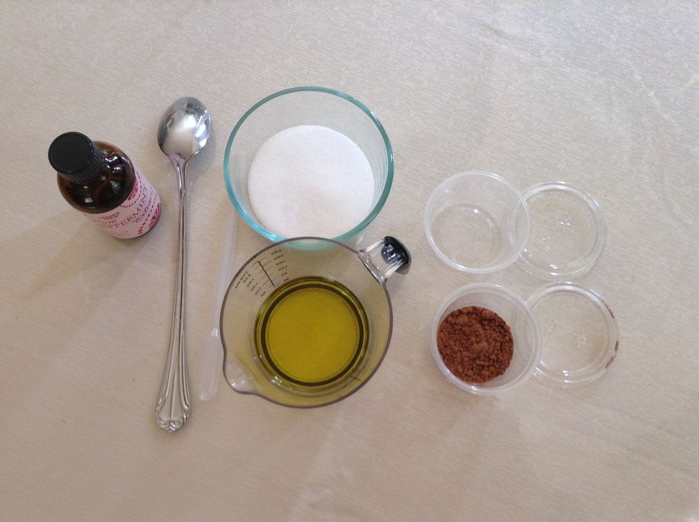 First get the esentials 1 teaspoon cocoa powder, 2 tablespoons sugar, 1 tablespoon oil of your choice, 15 drops of Peppermint extract, something to mix with and a container to store the lip scrub in