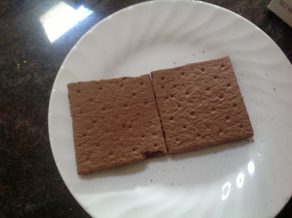 First, get two graham crackers and put them on a plate
