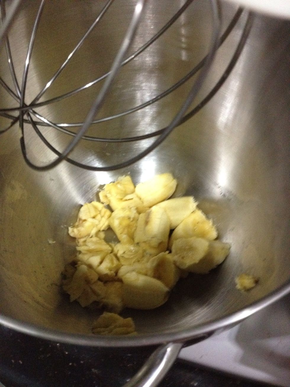 First, get your bananas and roughly chop them up. Then whisk it, either with a stand mixer or by hand, till it's mashed and 'fluffy'.