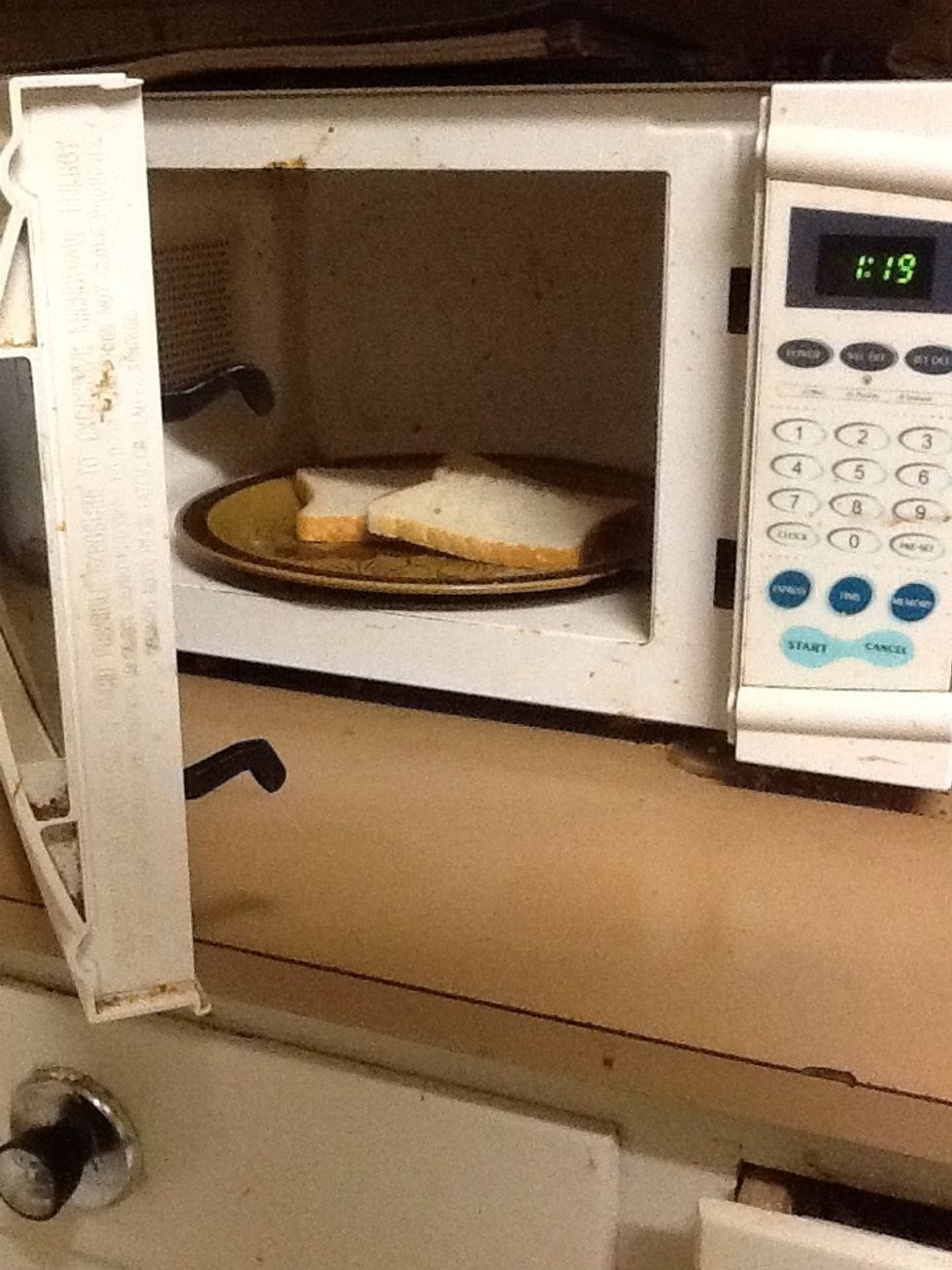 First heat up the bread in the microwave for 30 seconds.