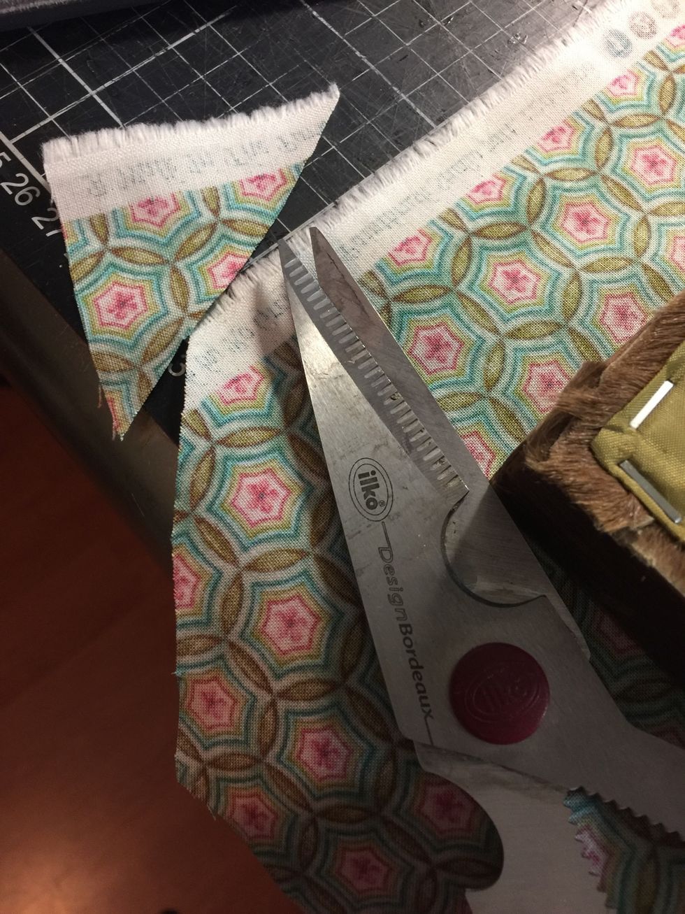 First I cutted the corners in a triangle form and discarded them each corner