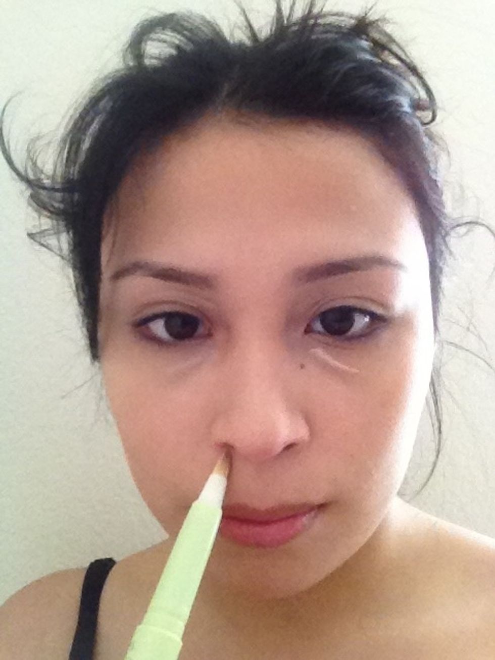 First, I'll take my concealer and apply it to my under eye circles, under my nose to cover up redness, and on my eyelid.