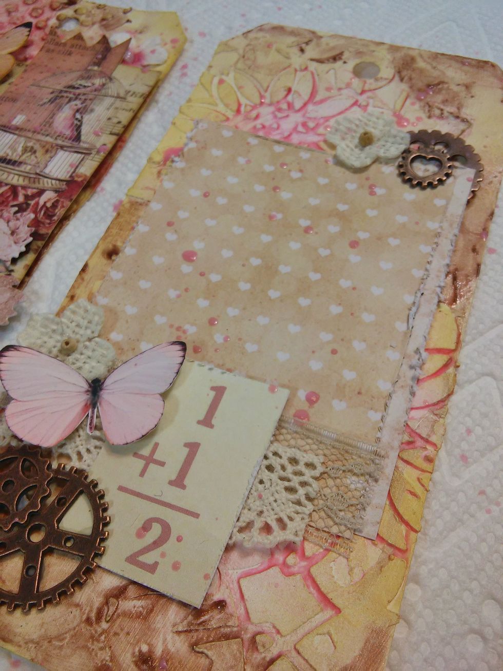 First I'm going to flick some watered down paint and white gesso sporadically on the tags, for even a little more interest! :)