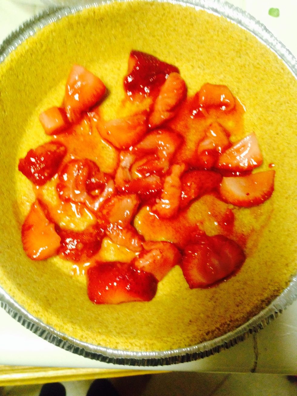 First I put the strawberries in crust and make sure there coated evenly