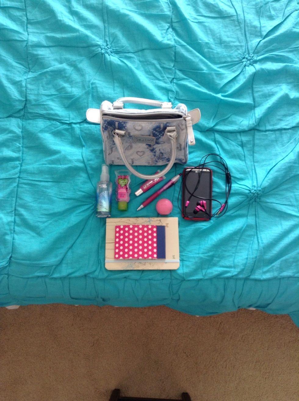 First, I want to fit in my small purse a miniature perfume, small hand sanitizer, lip gloss, a pen, EOS lip balm, my phone, headphones, and two different sized journals.