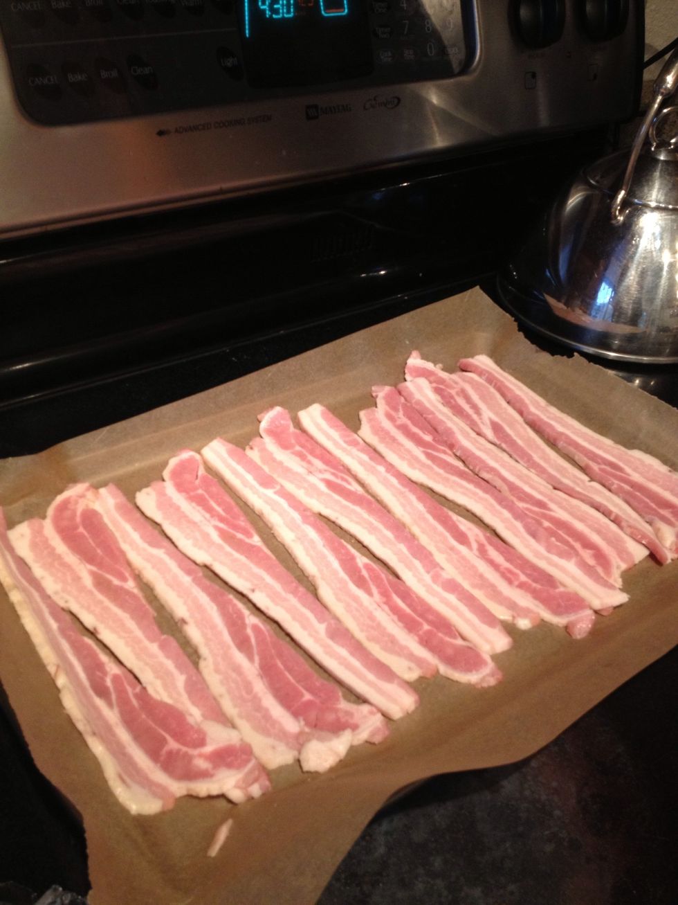 First lay out that amazing bacon onto a piece of parchment paper and place in a 425F oven until brown and crispy! Watch it though so it doesn't burn \ud83d\ude01