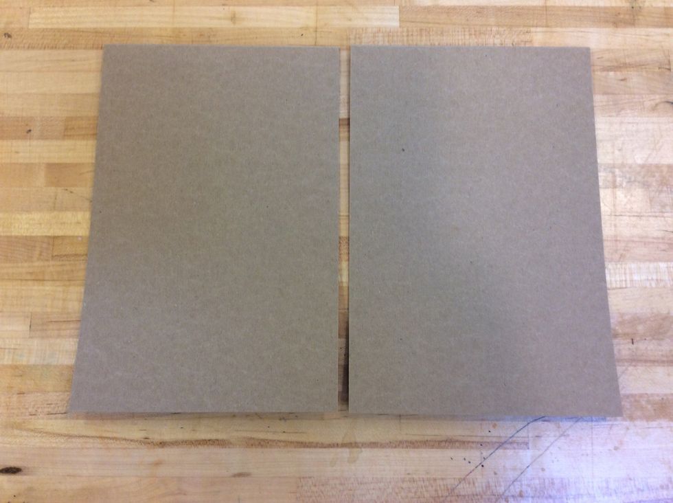 First, lay the two sheets of cardboard side-by-side with a quarter inch space between them.