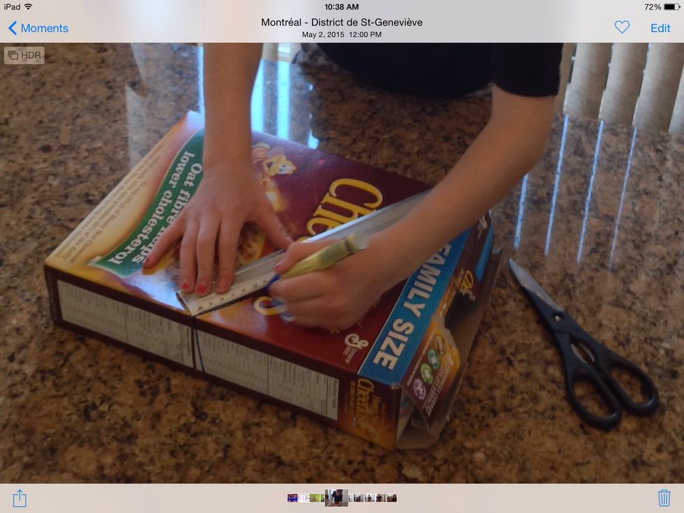 First lay your cereal box down then grab your ruler and draw a diagonal line from one corner to the  opposite side