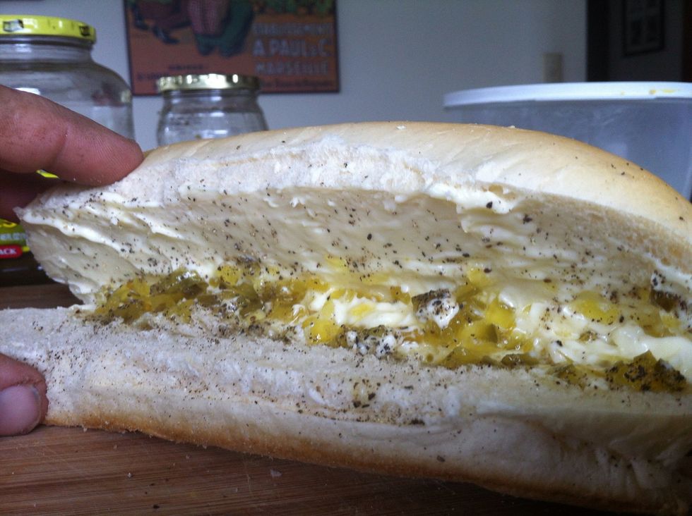 First. Layer in a  good amount of mayo to both sides of the roll. Then a lighter layer of relish on both sides.  Pepper and salt.