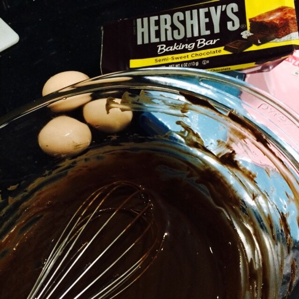 First, melt the butter and chocolate in a bowl. You can do this in the microwave (which is what I always do) or over a double boiler. Then let it cool slightly.