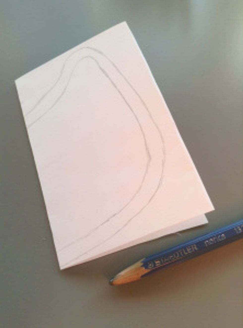 First of, fold your paper in half and sketch an outline of half of your owl onto it.  Add a seam allowance and cut it out.