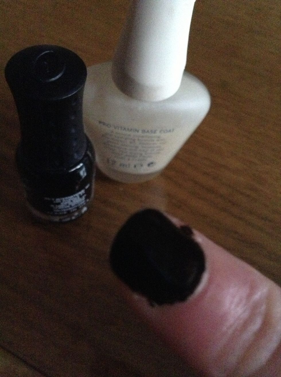 First, paint your nail with the base coat and black.
