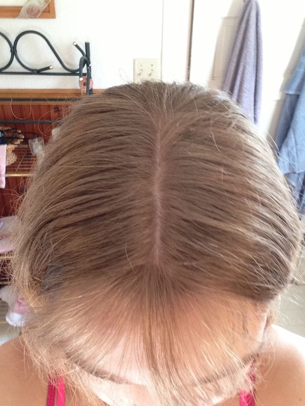 First, part your hair in the middle.