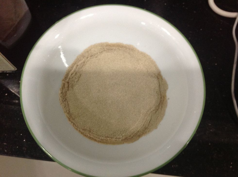 First, place warm water in a bowl and sprinkle yeast packets on it.