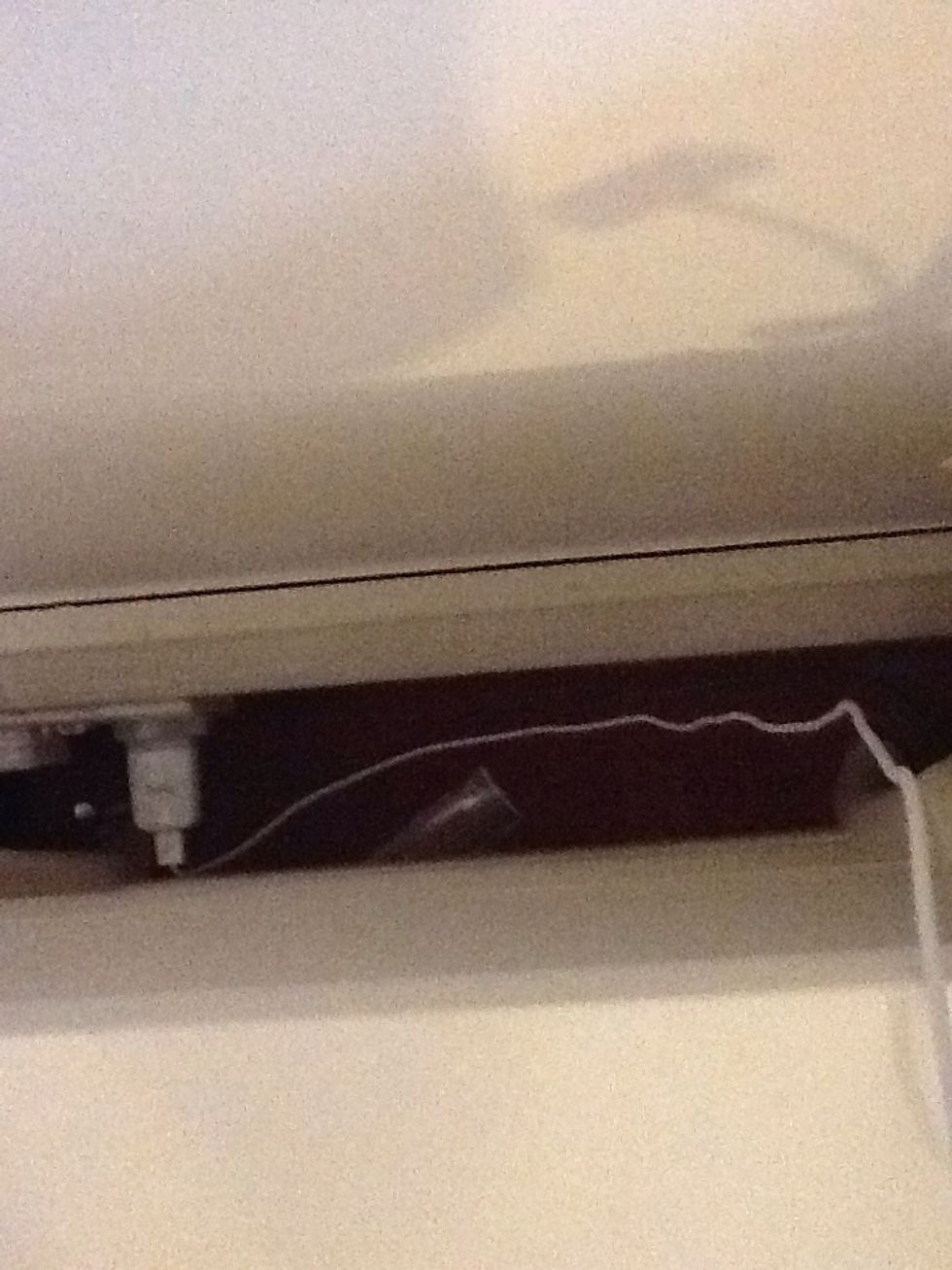 First plug in your iPad charger behind your night stand