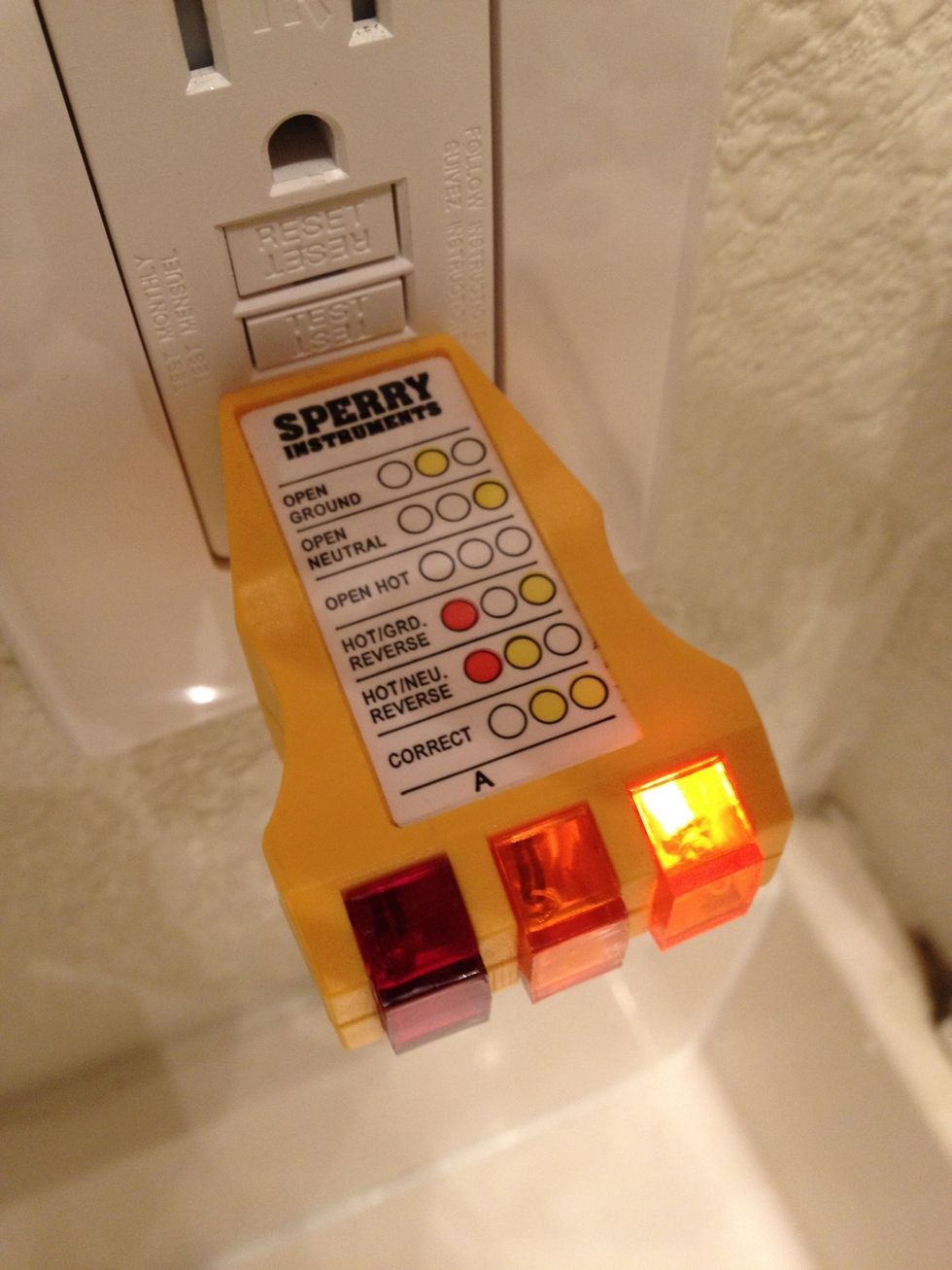 First, plug in your outlet tester to see if there's any power to the plug. If any of the orange lights come on, don't start touching wires. Turn off the breaker at the main electrical panel.