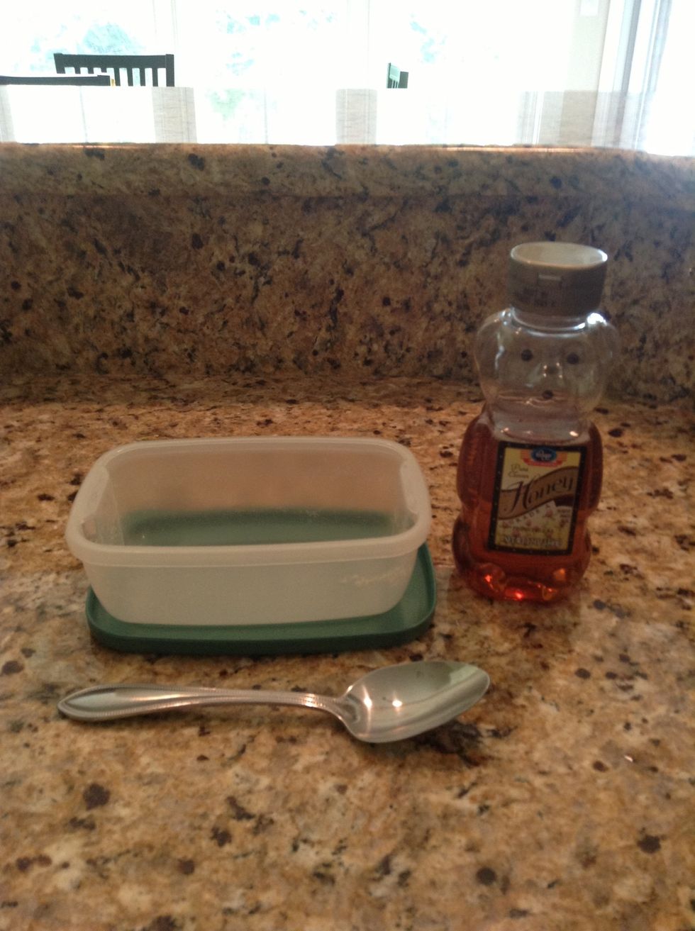 First, pour 3 tablespoons of pure honey into your container.