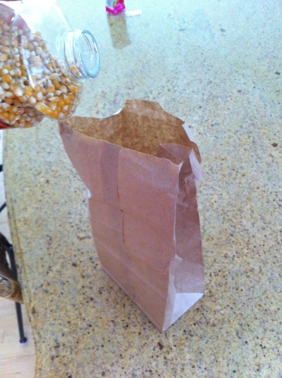 first, pour desired amount of kernals in the brown bag...(a lot goes a long way!)