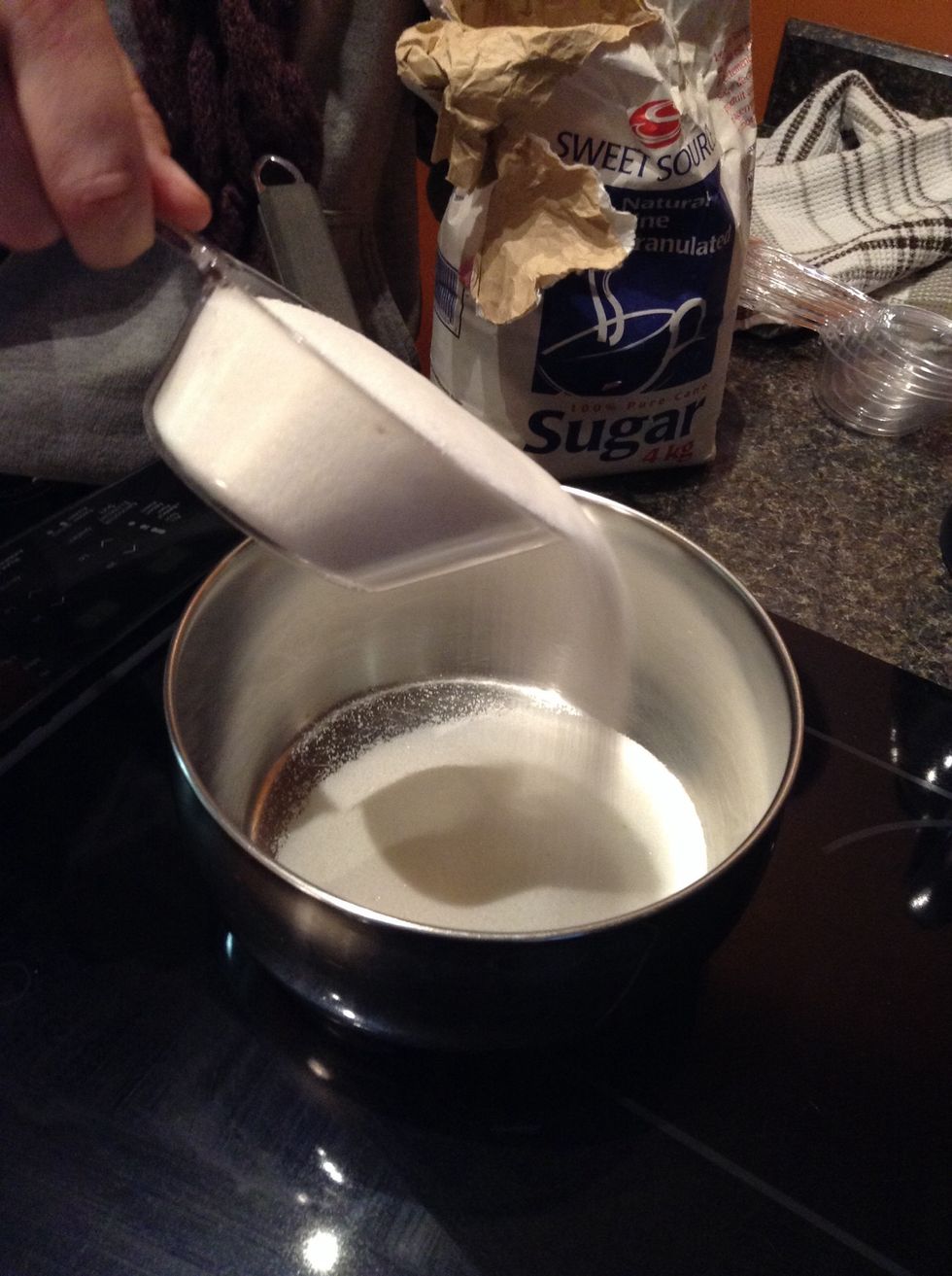First, pour your 2 cups of white sugar into your medium sized pot.