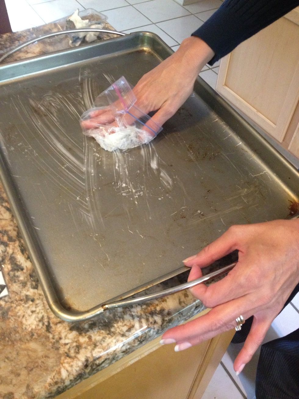 First prepare a 12.5x17.5in jelly roll pan by covering it with Crisco.
