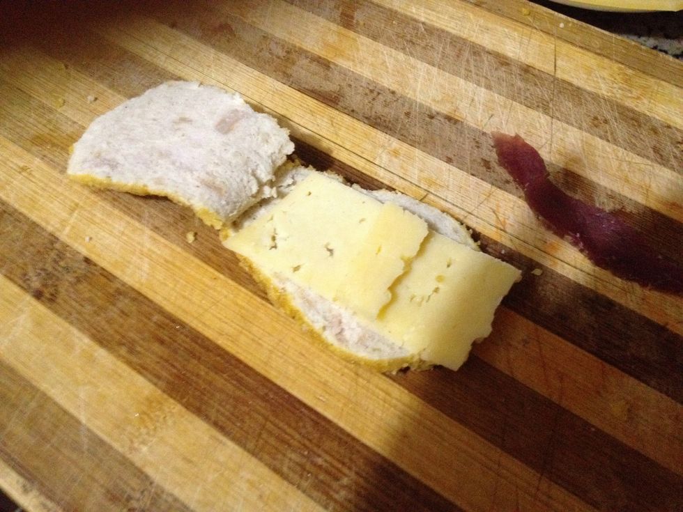 First put slice of chess inside the piece of chicken