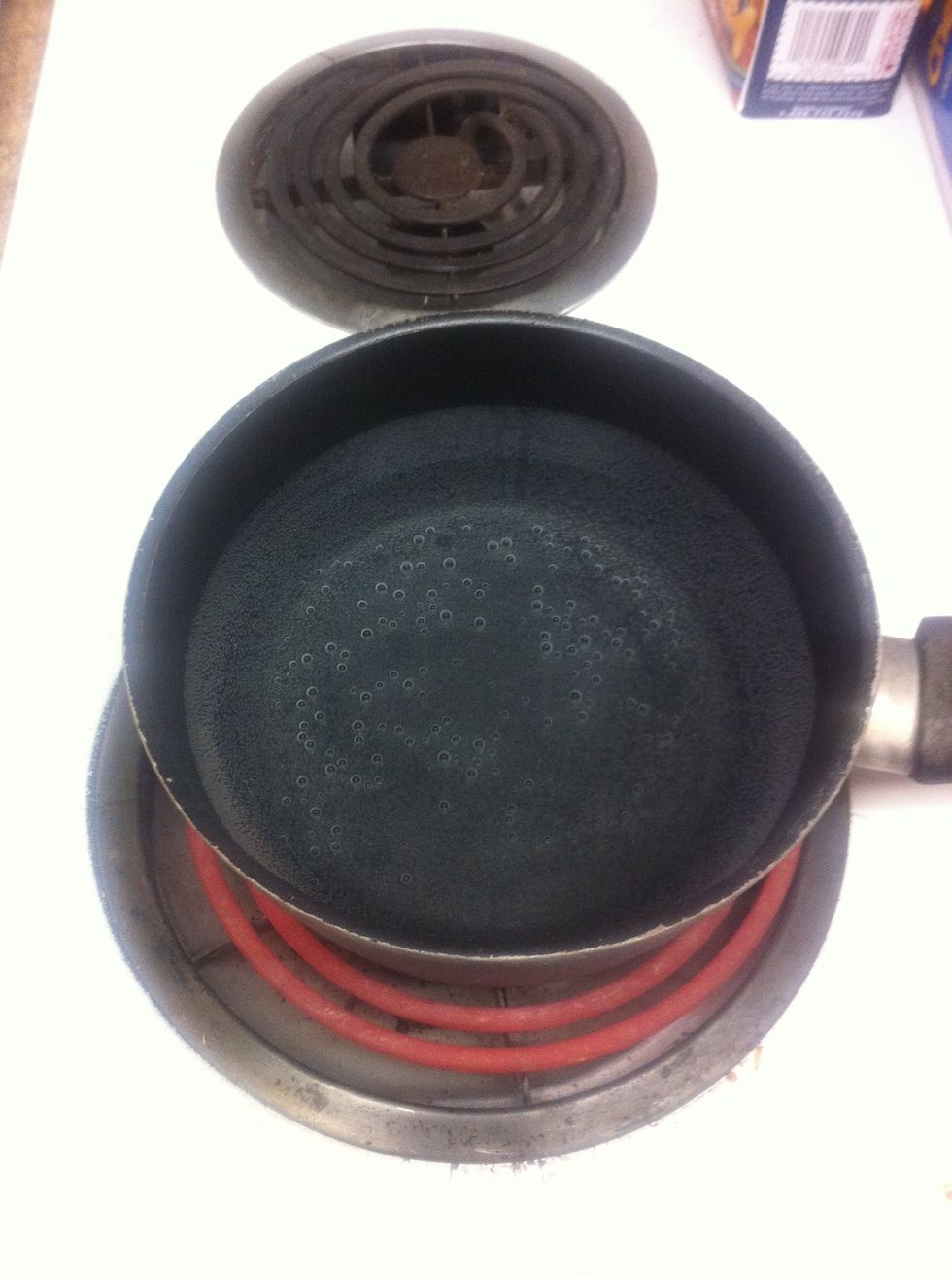 First put some water into a pot and wait for it to boil..