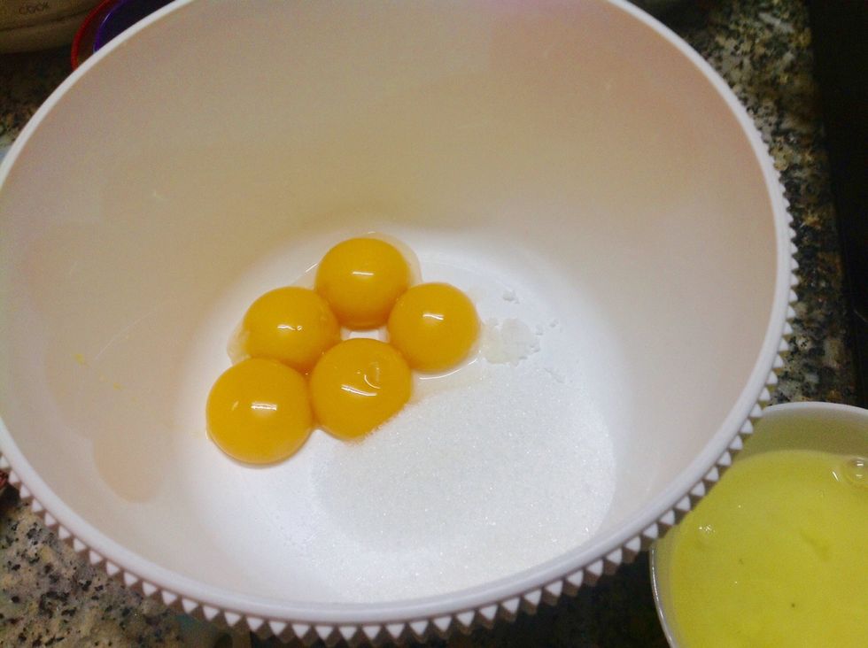 First, separeate the egg yolks and egg whites. Put the egg yolks, sugar and salt into a large mixing bowl.