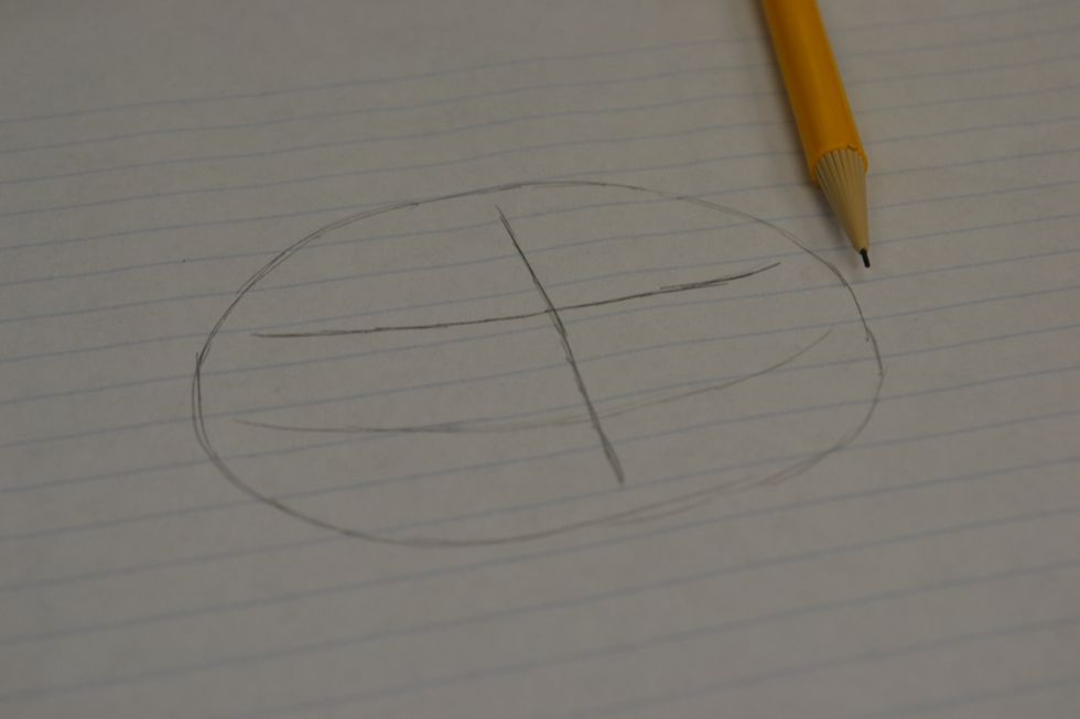 First, sketch a oval shape with 3 lines in the oval. One going straight down and two lines one longer than the other (bottom), and one shorter and at least a few cm. above. This is the head base.