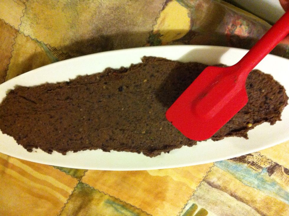 First spread black beans around the plate Have to go smoothly and flat, Blackbean should be blended with lime juice and cilantro and salsa to bind.