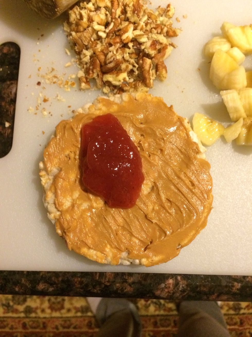 First spread peanut butter, then the strawberry jam. Yum!!