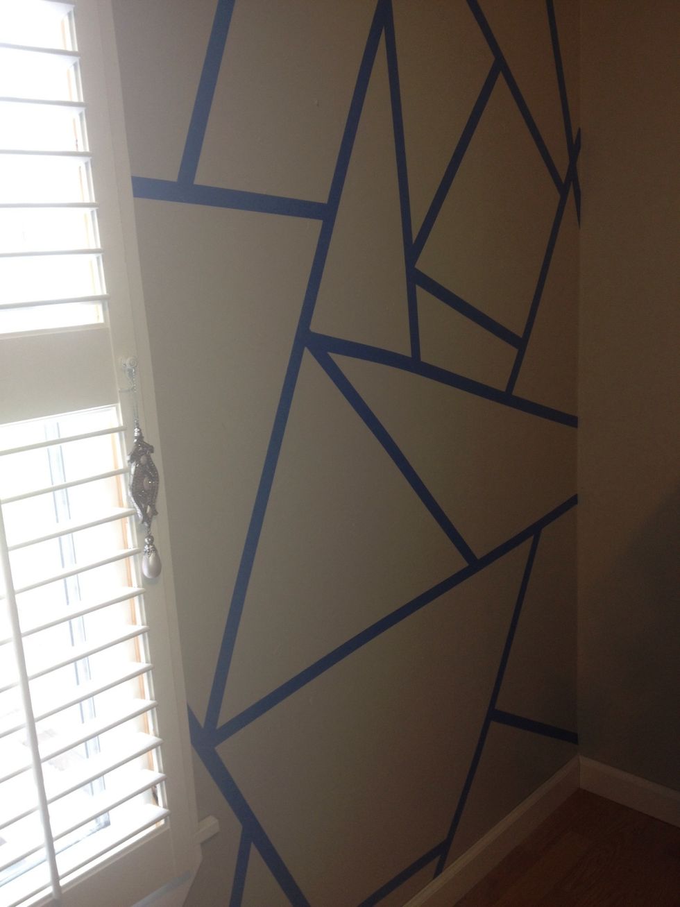 First stage of applying painters tape (on other side if window).