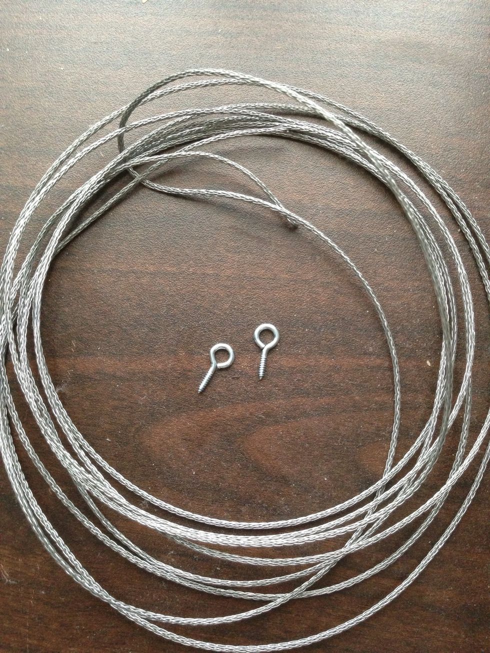 First start by cutting ~8 feet of the steel wire  and tie the ends through the screws as shown in the next two pictures.