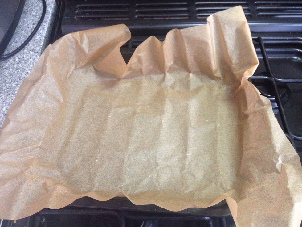 First start with lining your baking tray with grease proof paper.