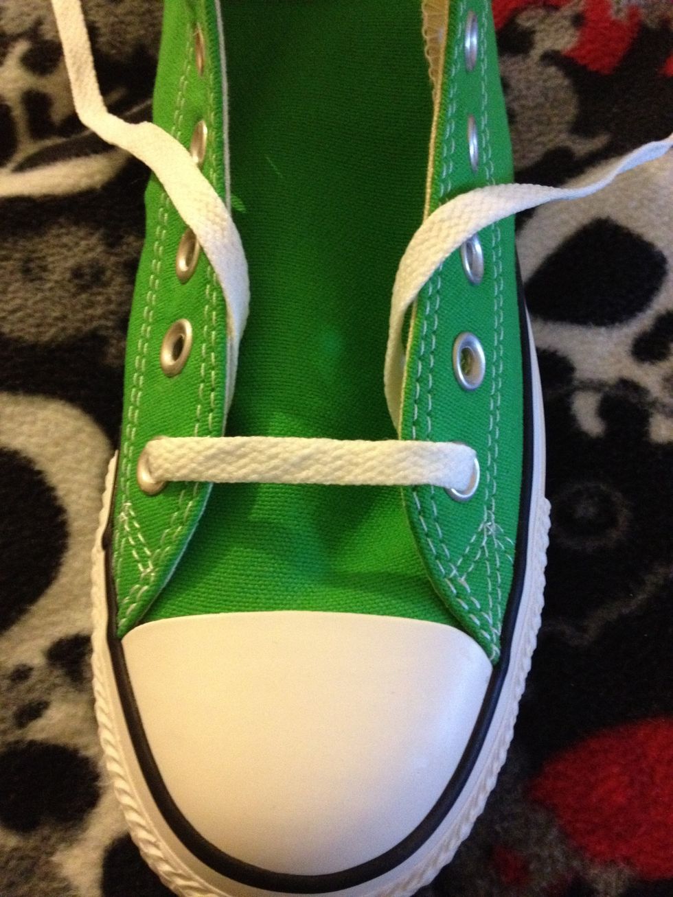 First, strip your laces down and thread them over the top of the bottom two eyelets.