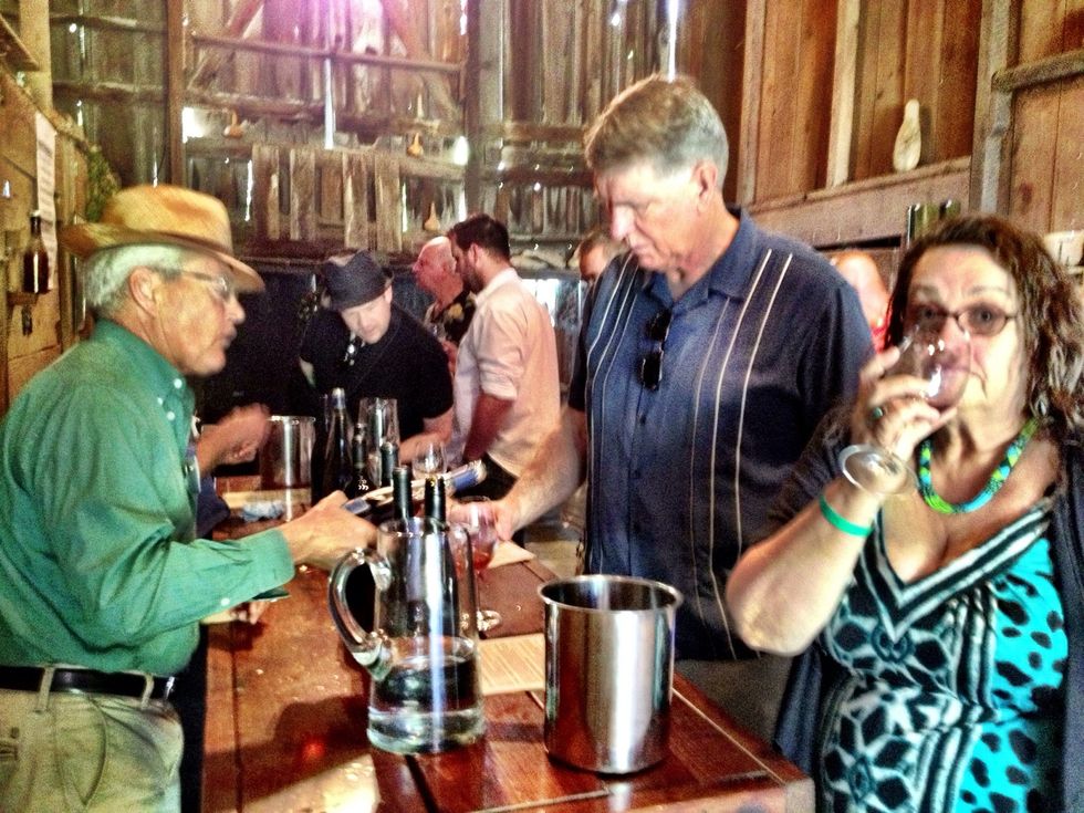 First swill the wine around in the glass and then take a whiff. That's me in the foreground next to my friend Steve. Mmmm....