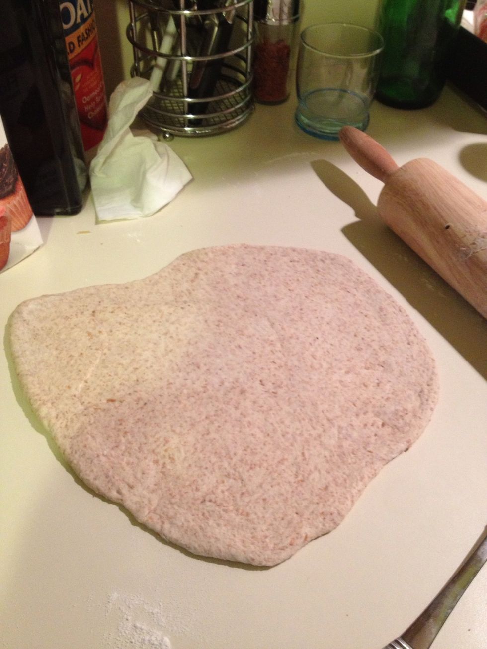First, take dough ball and cut evenly into the amount of calzones you are making. Then roll out the dough using flour and a roller. Continue rolling and adding flour until dough is not sticky and thin