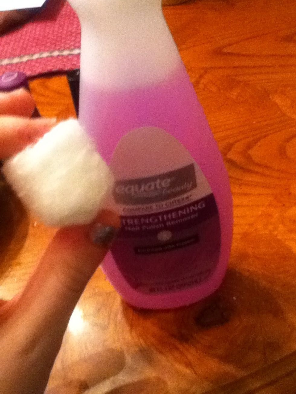 First, take the cotton ball. Soak it in nail polish remover and take off any excess color you had on your nails previously.