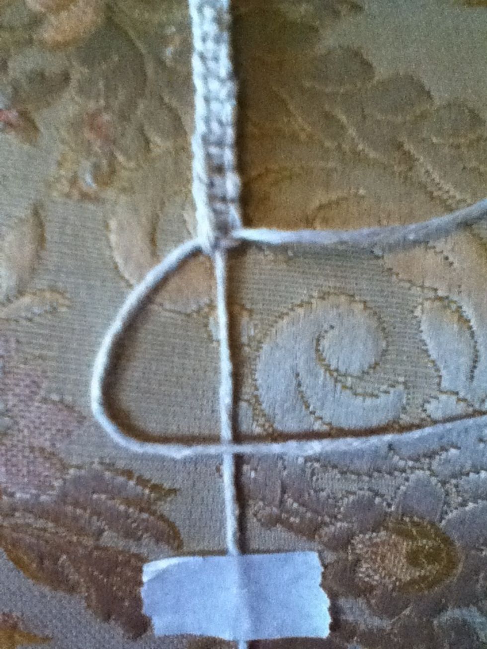 First, take the thread on the left and cross it over the middle one