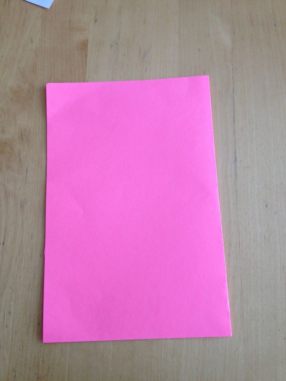 First take your piece of construction paper and fold it in half.