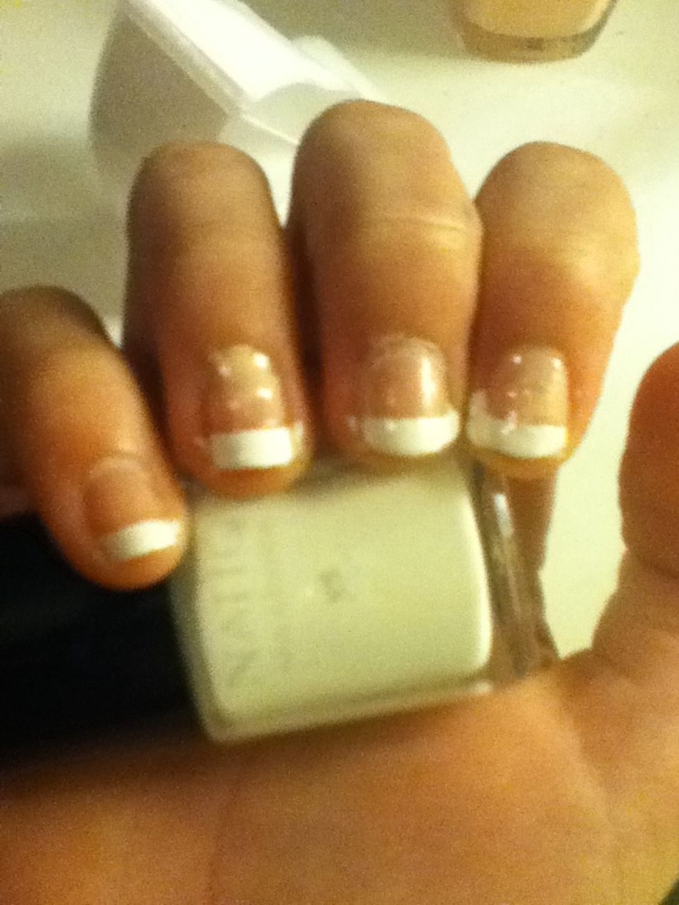 First, the design for your dominant hand (this is a simple design for easy painting). Using the white manicure polish, paint the tips of your nails.