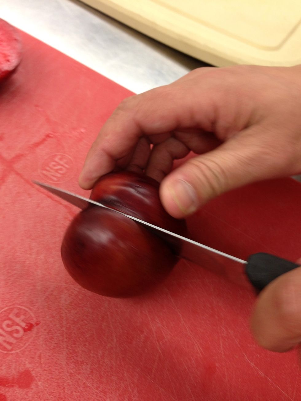 First things first. Let's cut our plumbs. Here's how I do it. With a small knife, cut down to the pit. Keeping the knife in the plum, roll the plum so the knife cuts a circle around the plum.