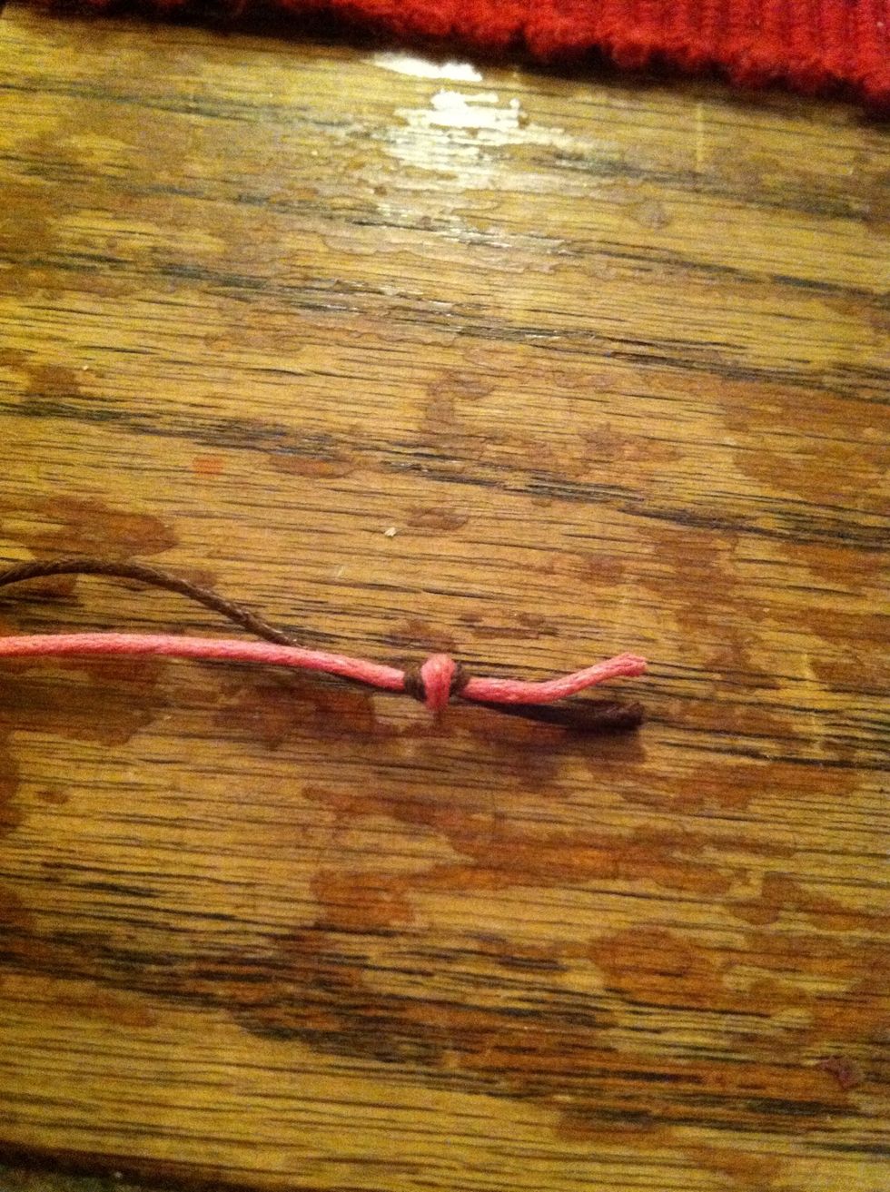 First tie an overhand knot close to the ends of your colored cords. (my guide on knots is coming as soon as I can finish taking the pictures)