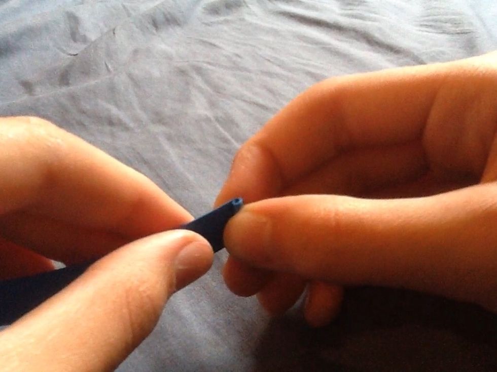 First tightly fold the end of one of the strips into a curl.\ud83c\udf00