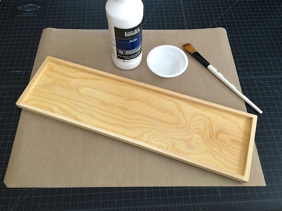 First up... you'll need Gesso, a paint dish, paint bush and your raw wood sign (be sure to sand the sign first to smooth out any rough edges). Gesso will prime/prep the surface for the acrylic paint.