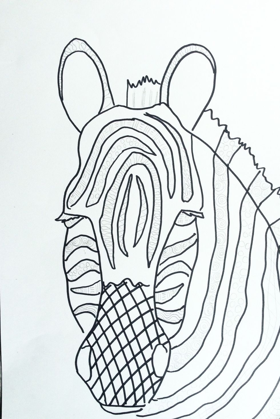 First, Use a pencil to add a variety of patterns to the black areas of your animal. Next, use black permanent marker to fill in your patterns.