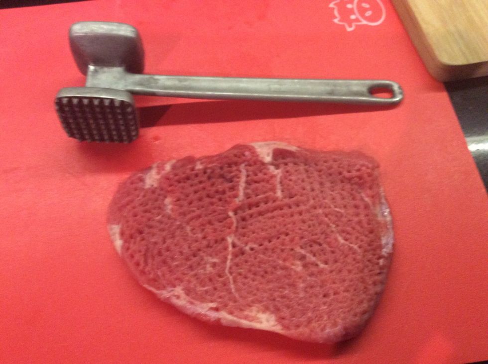 First use the meat mallet to beat the meat on both sides so it is ready to go on the pan