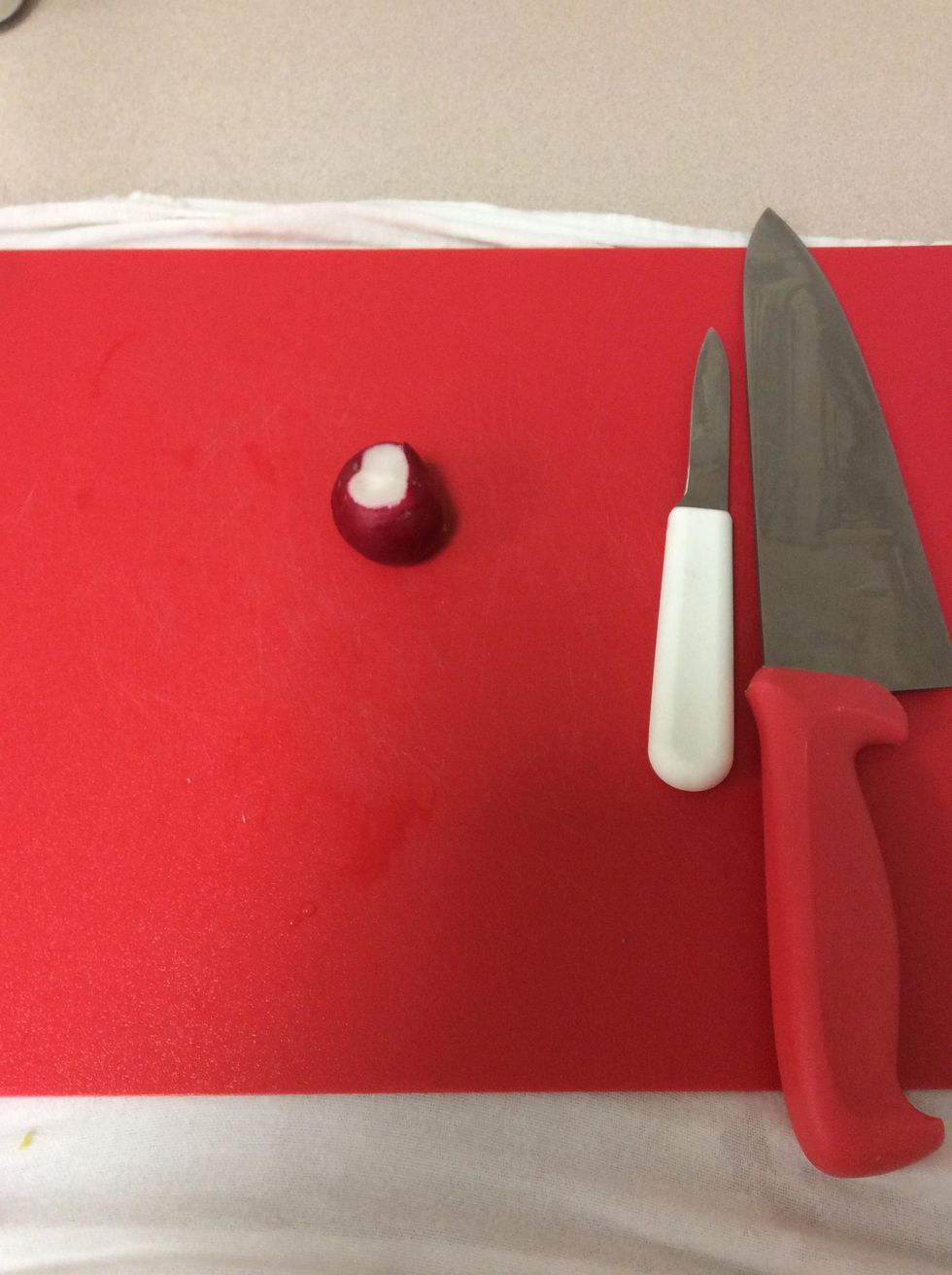 First wash and dry off the radish. Then with a paring knife cut off stem part and the top of the radish.